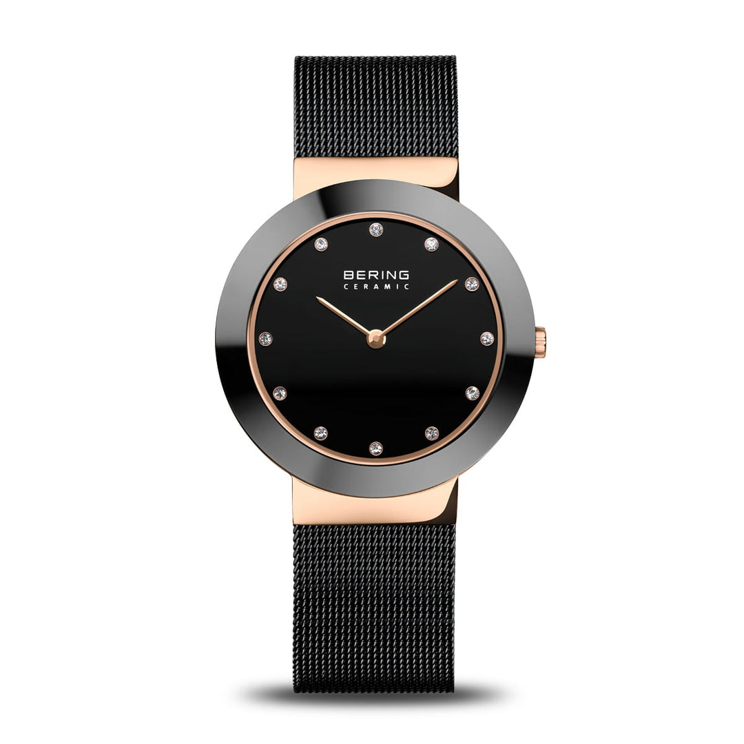 Het Bering 11435-166 horloge heeft een zwarte mesh band, zwarte ronde wijzerplaat met Saffierglas, kristallen uurmarkeringen en gouden wijzers. Het is gelabeld als BERING CERAMIC en bevat Quartz-uurwerk voor nauwkeurige tijdwaarneming.