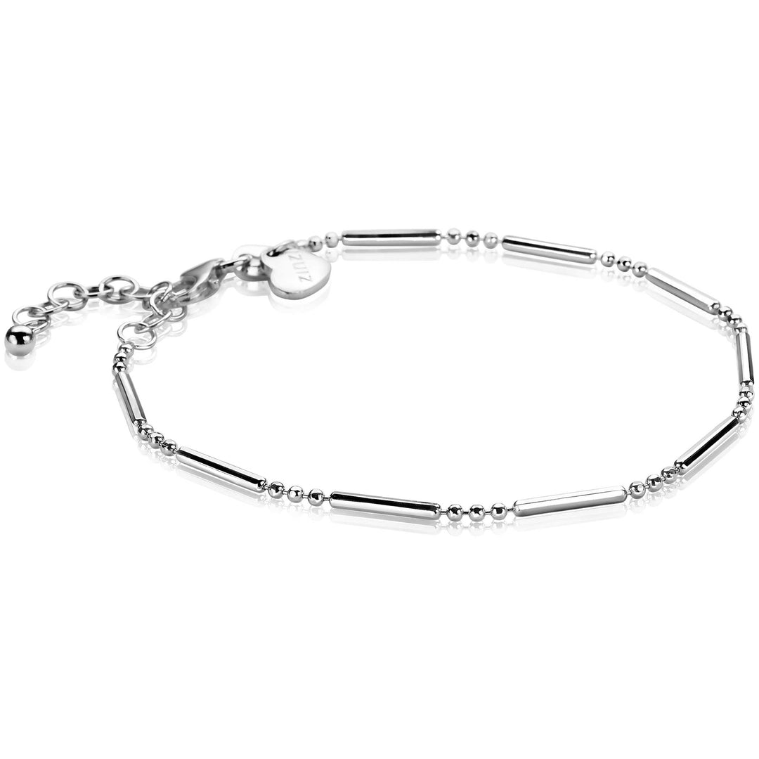 De Zinzi Armband Zilver Zia1452 van Zinzi is voorzien van afwisselend kleine kraaltjes en cilindervormige schakels, een verstelbare ketting met een hartjesbedel bij de sluiting en een gepolijste afwerking voor een glanzende look.