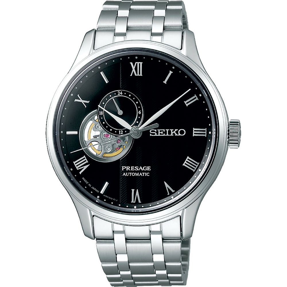 Reloj de hombre Seiko Presage con esfera negra, correa de acero inoxidable y detalle de movimiento visible.