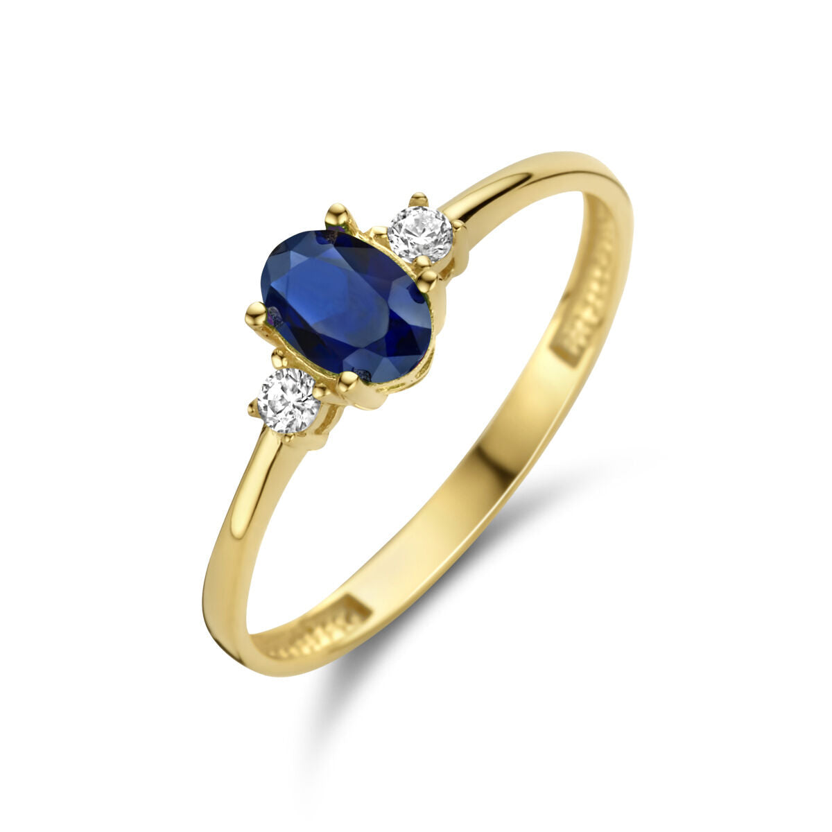 Anillo de trilogía en oro amarillo de 14K con zafiro sintético y circonitas.
