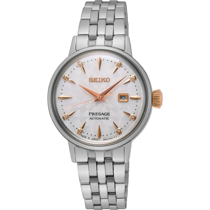 Het Seiko Presage dameshorloge SRE009J1, met een Hardlex mineraalglas kast, heeft een automatisch uurwerk. De zilveren metalen schakelband past bij de witte wijzerplaat met goudkleurige markeringen en wijzers. Een gestructureerde achtergrond en datumvenster op 3 uur maken de tijdloze elegantie compleet.