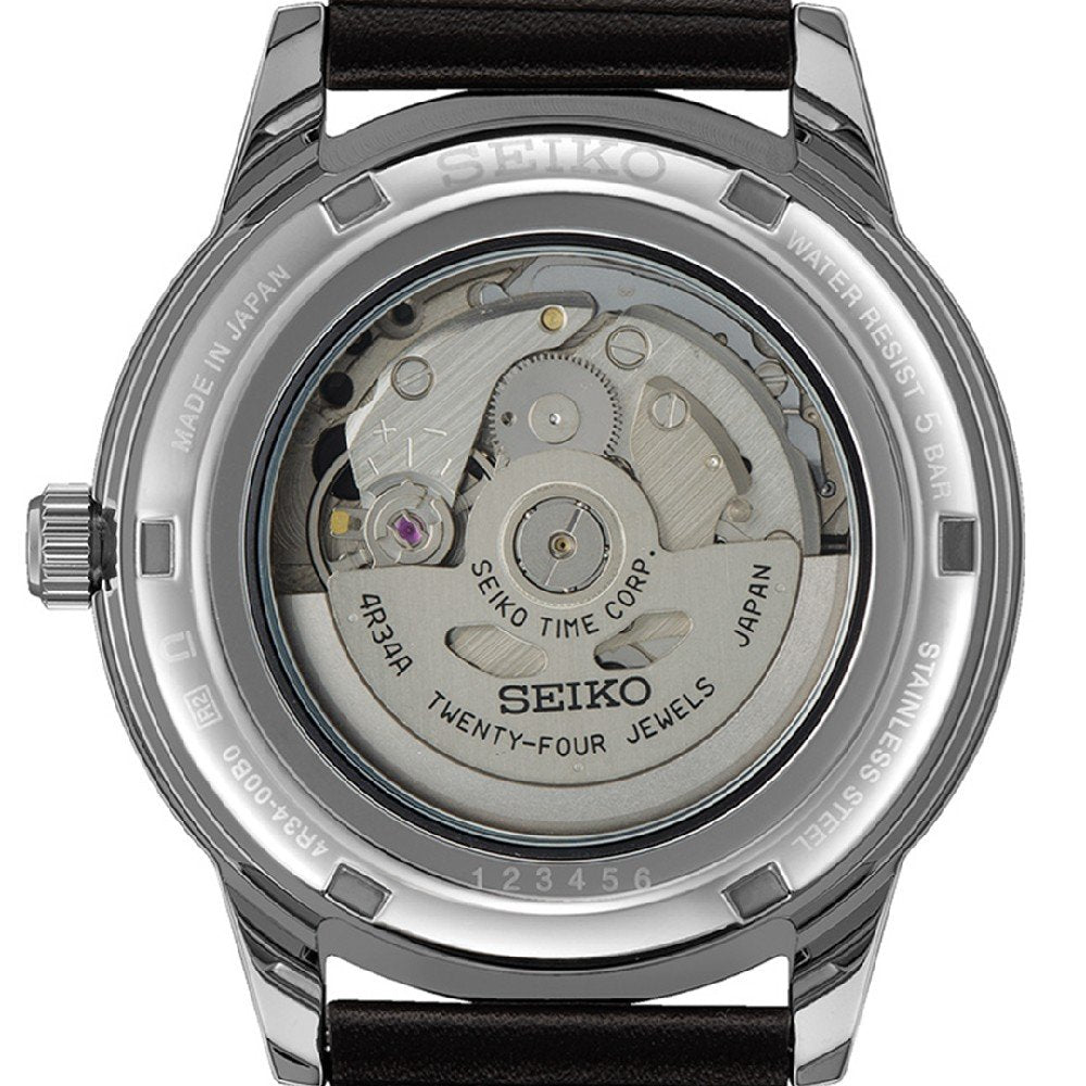 De afbeelding toont de achterkant van een Seiko Presage heren horloge SSK013J1, met de transparante achterkant die het ingewikkelde automatische uurwerk onthult. Dit horloge heeft een roestvrijstalen kast en een zwarte leren band.