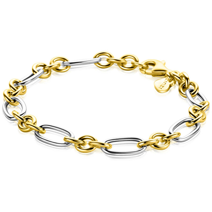 De Zinzi Armband zilver ZIA2667 19,5cm is een chique bicolor armband van Zinzi, met afwisselend ovale en ronde schakels in goud- en zilvertinten, afgewerkt met een gouden karabijnsluiting en een klein goudkleurig label.