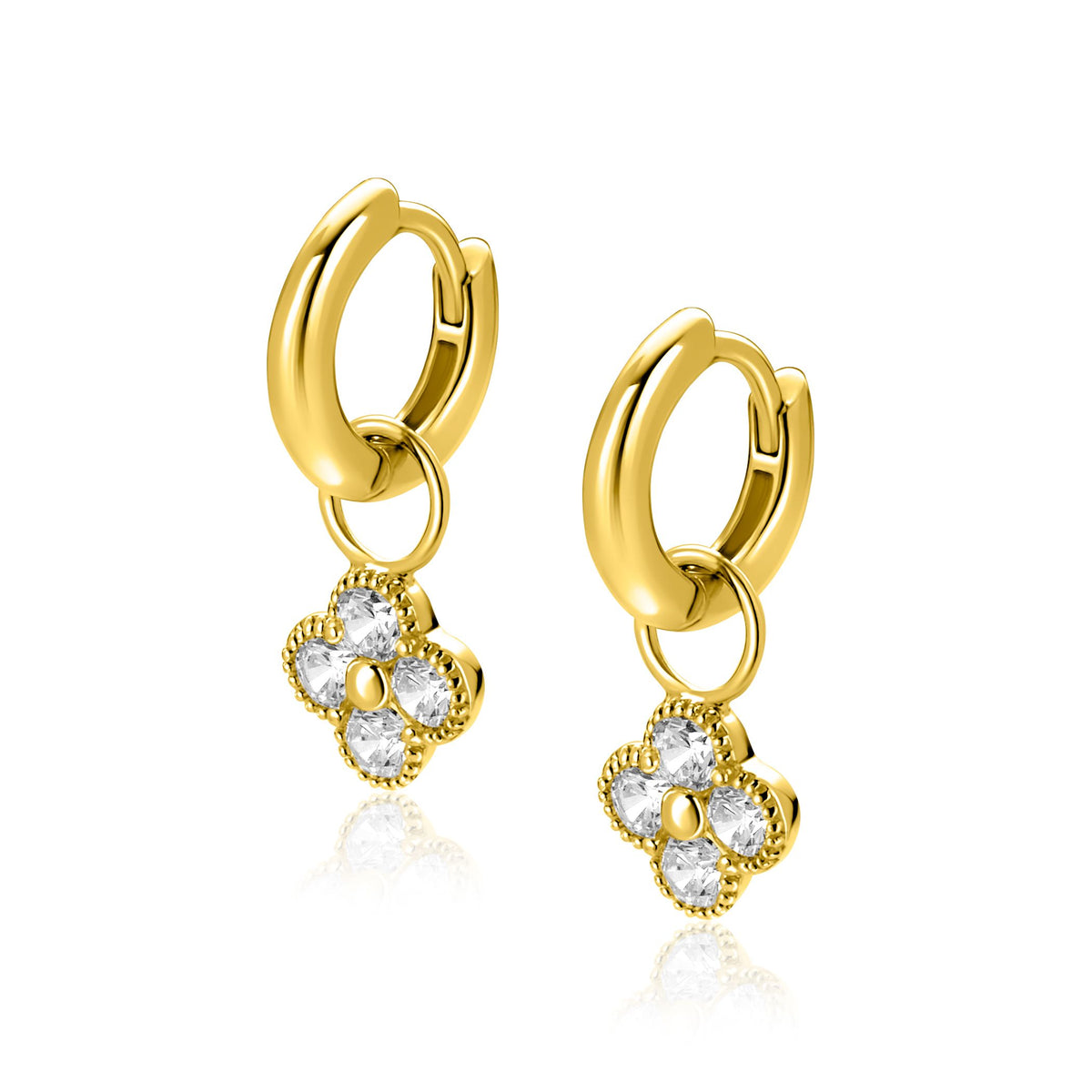 Pendientes de aro dorados con colgante en forma de flor y piedras brillantes.