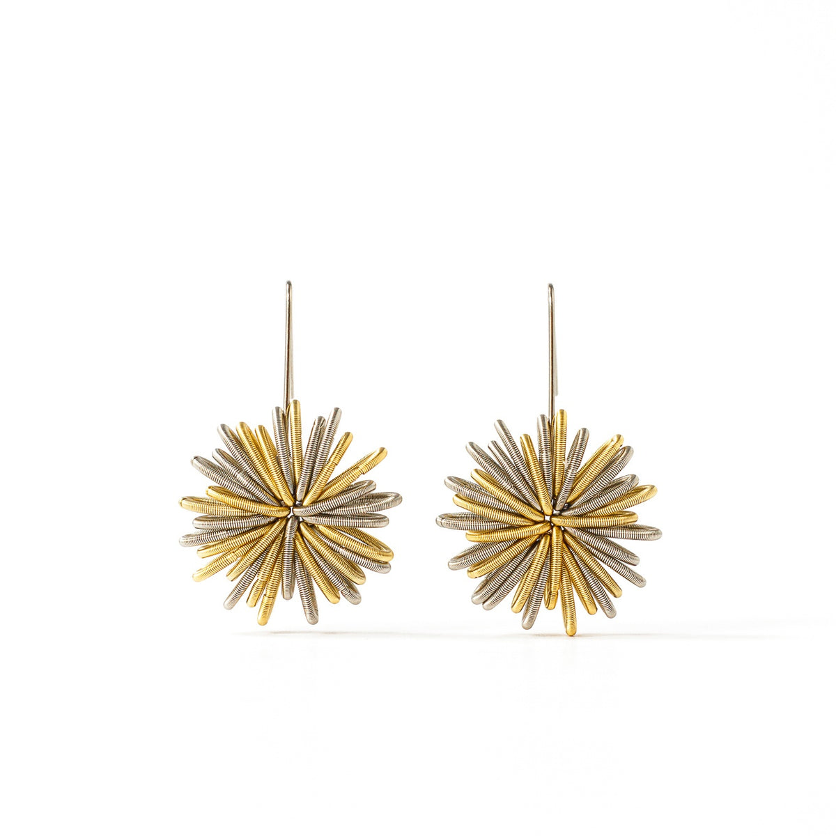 Pendientes largos de plata con diseño en forma de estrella y detalles dorados.