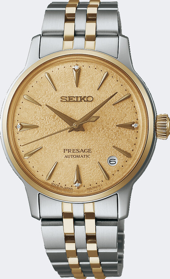 Reloj automático de dama con esfera dorada, caja bicolor de acero y oro, y brazalete de eslabones.