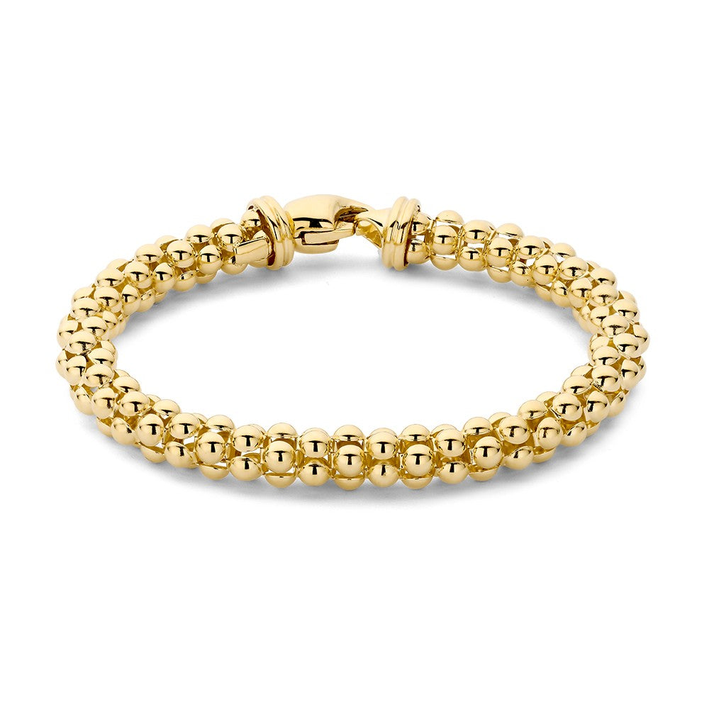 Pulsera de oro amarillo con cuentas redondas brillantes.