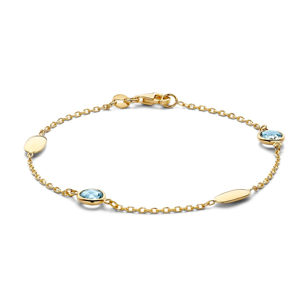 Pulsera de oro amarillo con piedras preciosas azules y eslabones alternos.