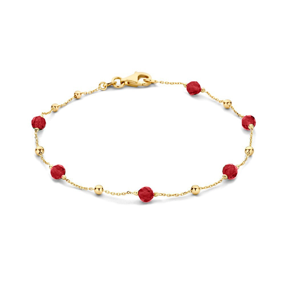 Pulsera de oro amarillo con circonitas y cuentas rojas.