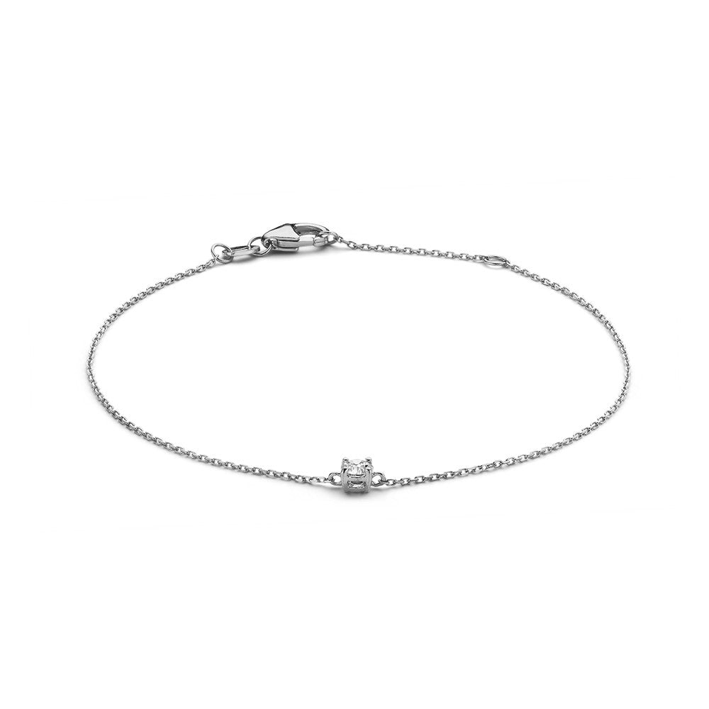 Pulsera de oro blanco con un diamante de 0,15 quilates en el centro.
