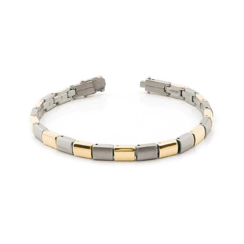 Pulsera bicolor de titanio con eslabones en tonos plateado y dorado.