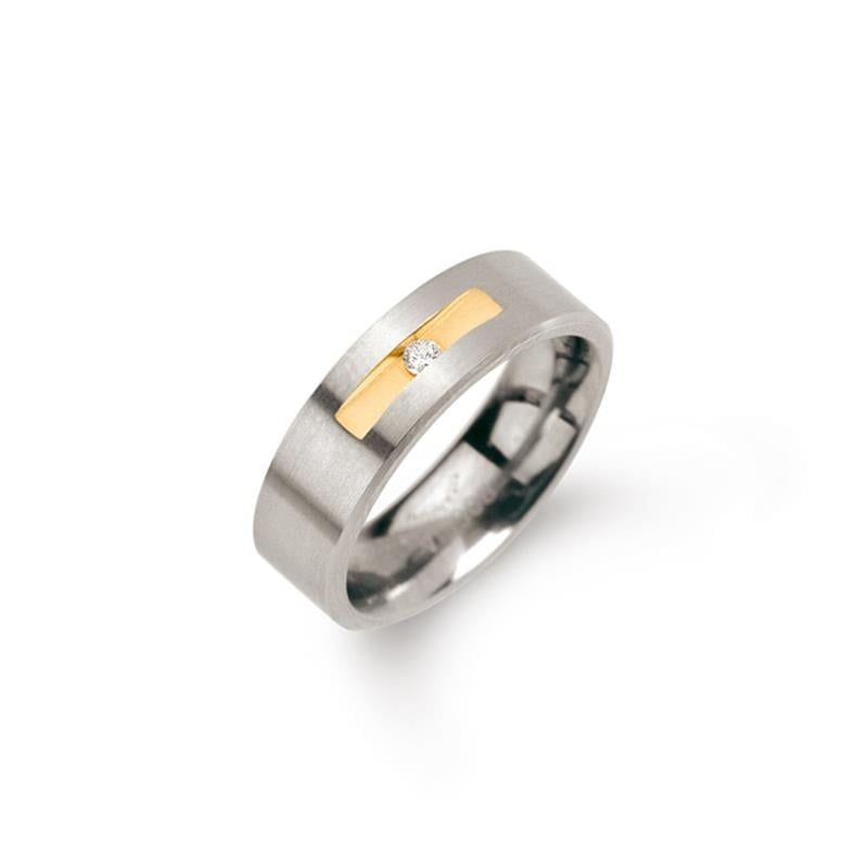 Anillo de titanio bicolor con una banda dorada y un diamante de 0.03 ct en el centro.
