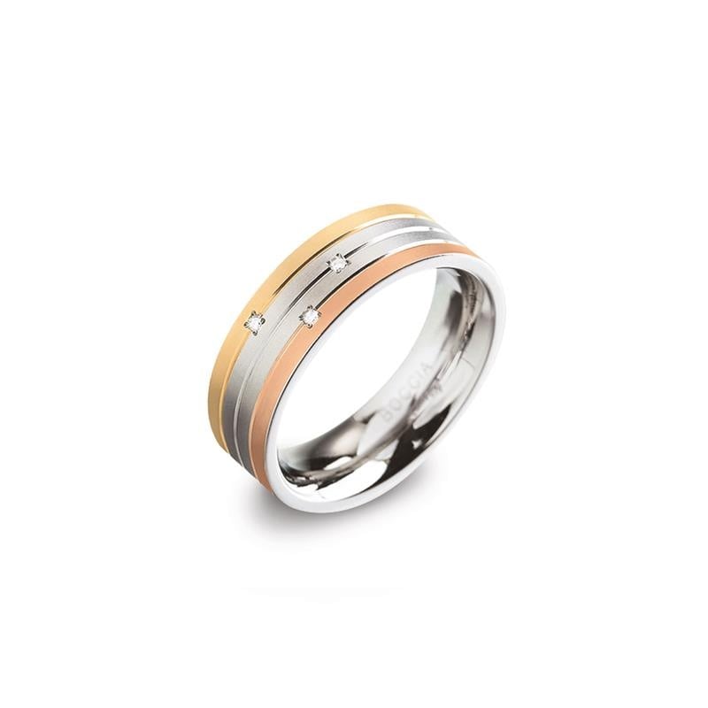 Anillo de titanio tricolor con detalles en oro y plata, decorado con tres pequeñas piedras.