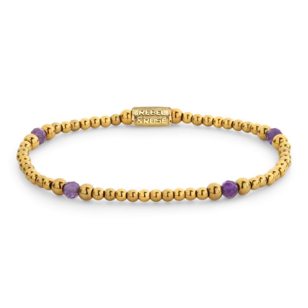 Pulsera dorada con cuentas moradas y detalles brillantes.