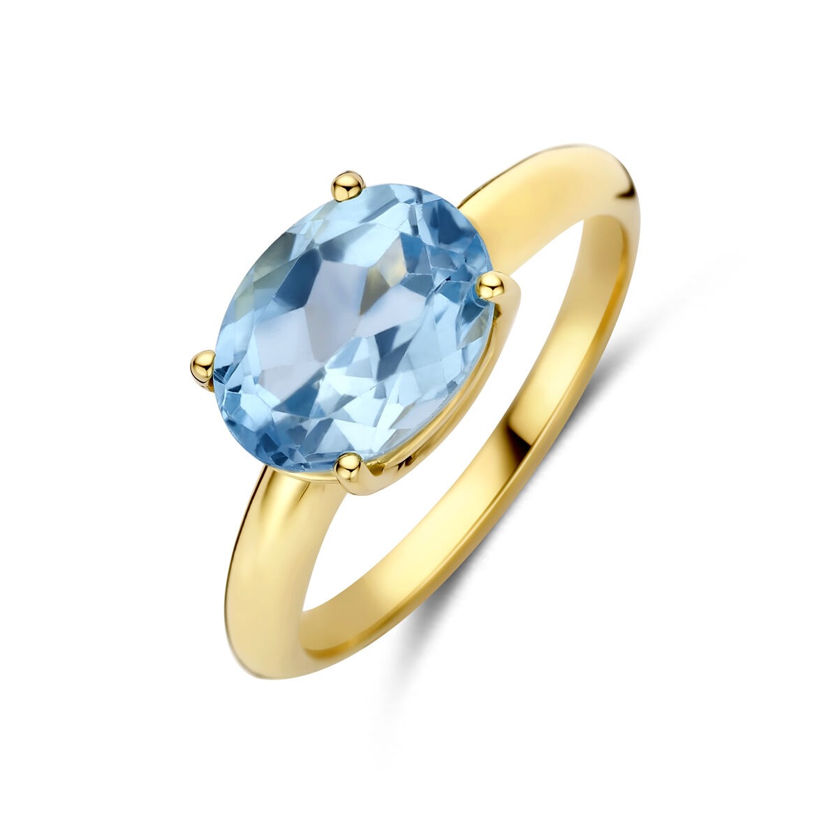 Anillo de oro amarillo de 14k con topacio azul ovalado en un engaste de cuatro garras.