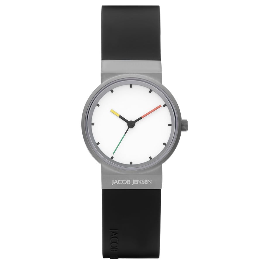 Reloj con esfera blanca, caja gris y correa de silicona negra, manecillas en rojo, verde y amarillo.
