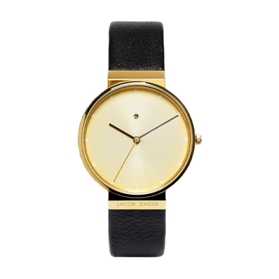 Reloj con esfera dorada, correa de cuero negra y diseño minimalista.