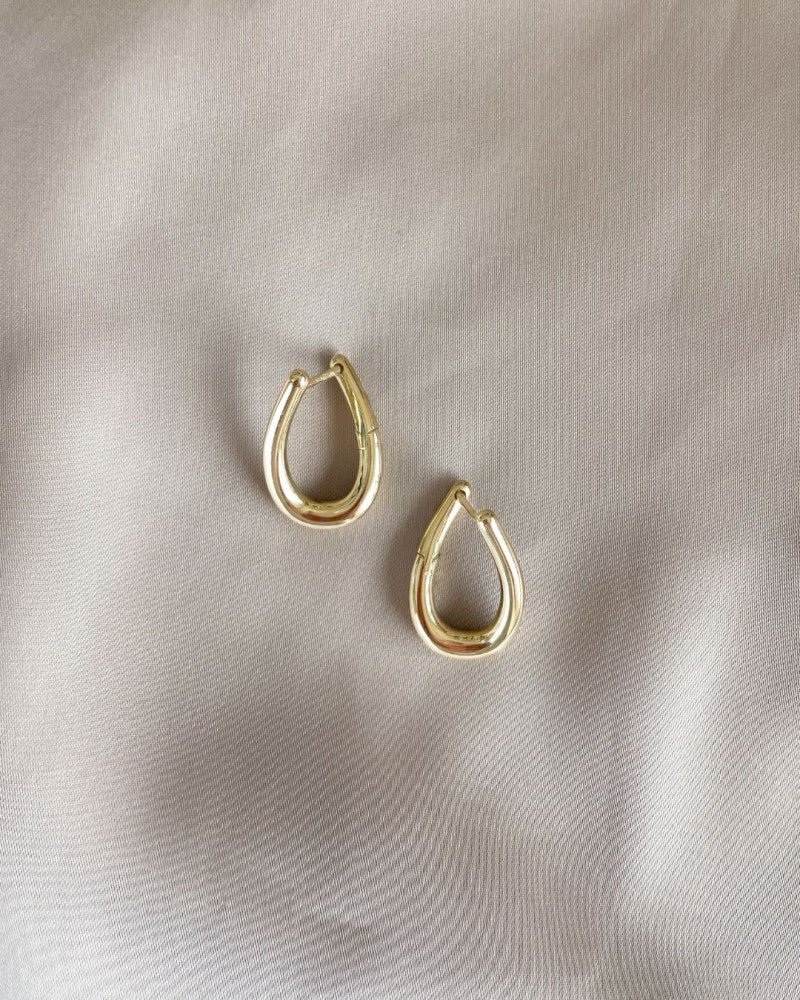 Aros de oro amarillo juguetones con giro – Elegancia en movimiento