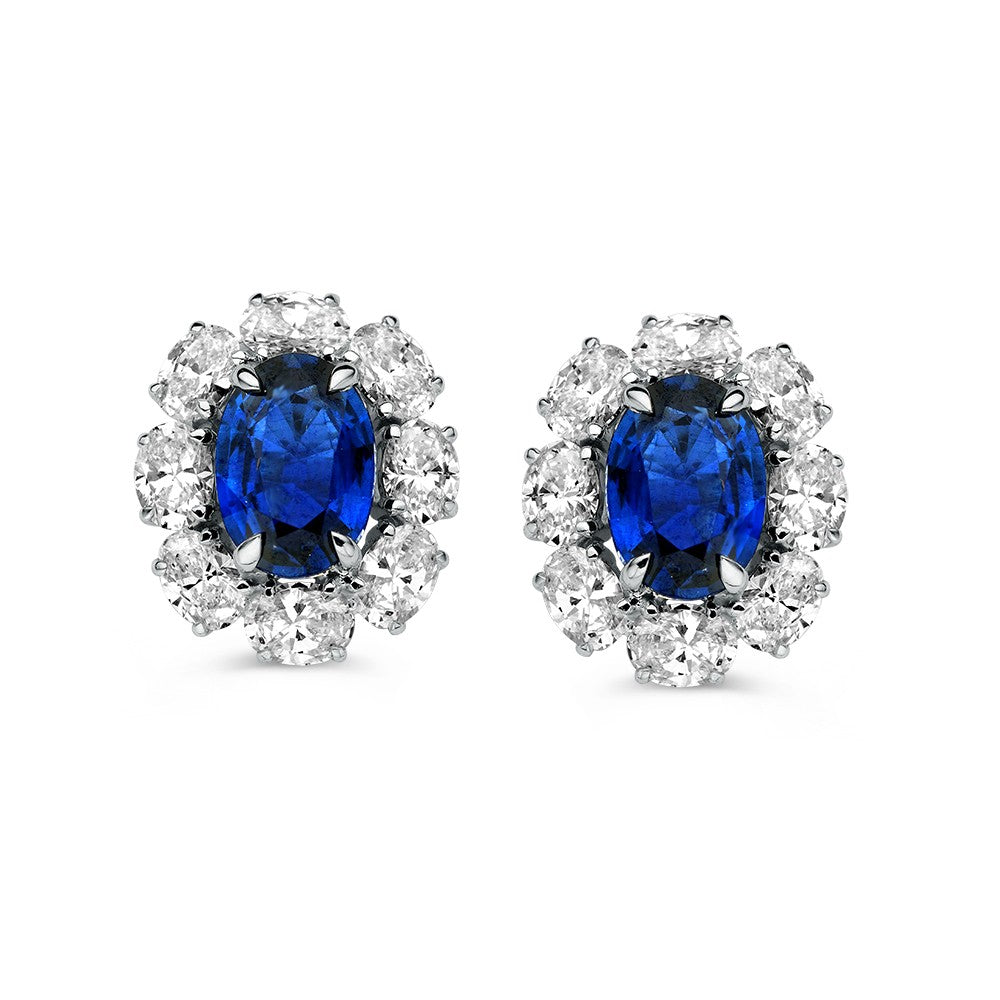 Pendientes bicolores con zafiro azul y diamantes brillantes, con forma ovalada y diseño floral.