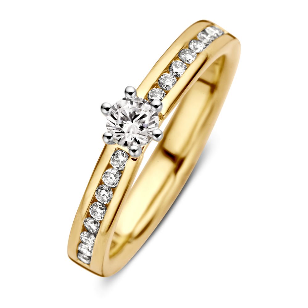 Anillo bicolor de oro amarillo y blanco para dama con diamante de 0.50 crt y detalles brillantes.