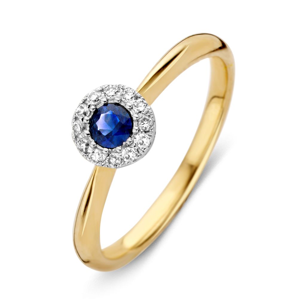 Anillo de dama de oro de 14 quilates con zafiro azul y diamantes en un diseño circular.
