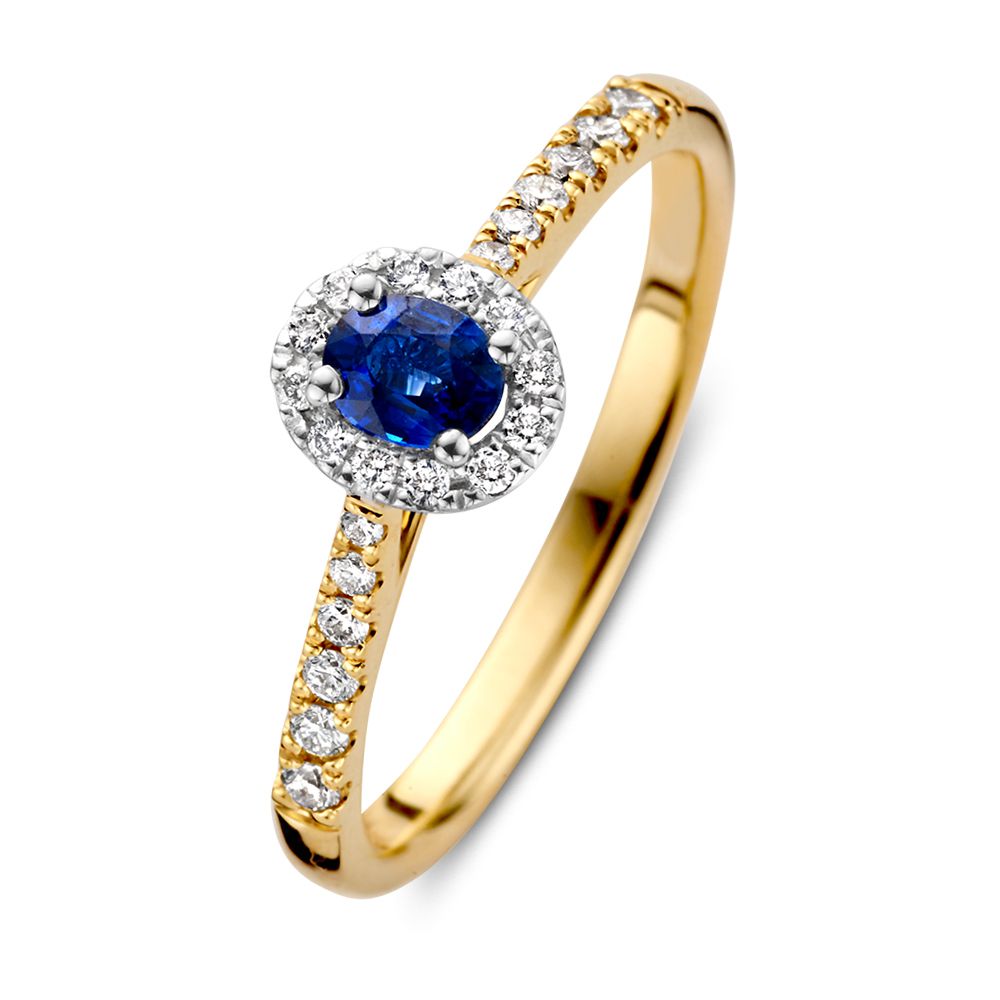 Anillo de dama bicolor de 14 quilates con zafiro ovalado azul y halo de diamantes.