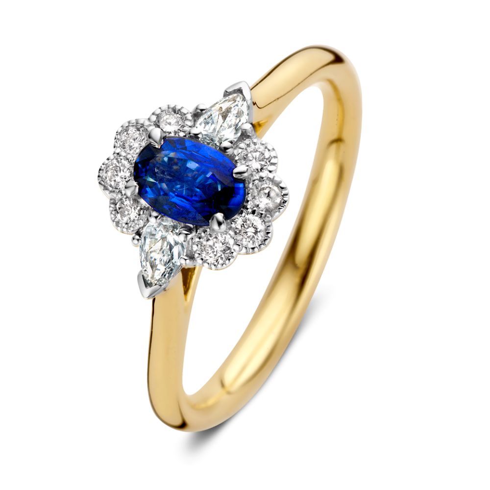 Anillo de dama de oro de 14 quilates con zafiro azul ovalado y halo de diamantes.
