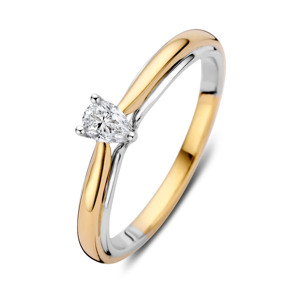 Anillo solitario bicolor de oro de 14k con diamante en forma de pera de 0.23 ct.