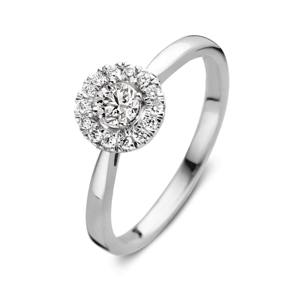 Anillo de oro blanco con un diseño circular y diamantes brillantes en el centro y alrededor.