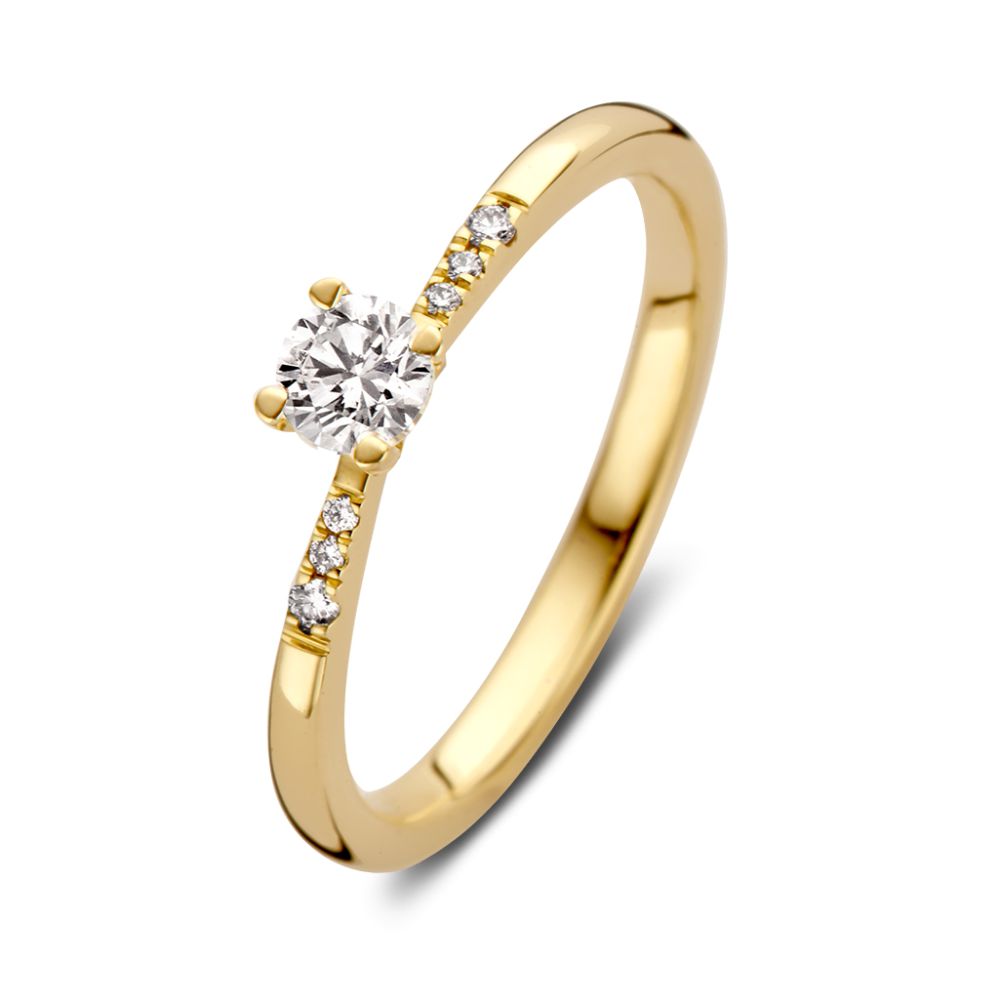 Anillo solitario de oro amarillo de 14 quilates con diamante brillante y piedras laterales.