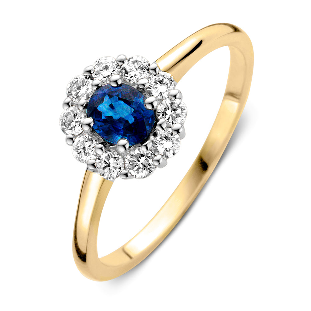Anillo elegante de oro amarillo y blanco con zafiro azul y diamantes brillantes.