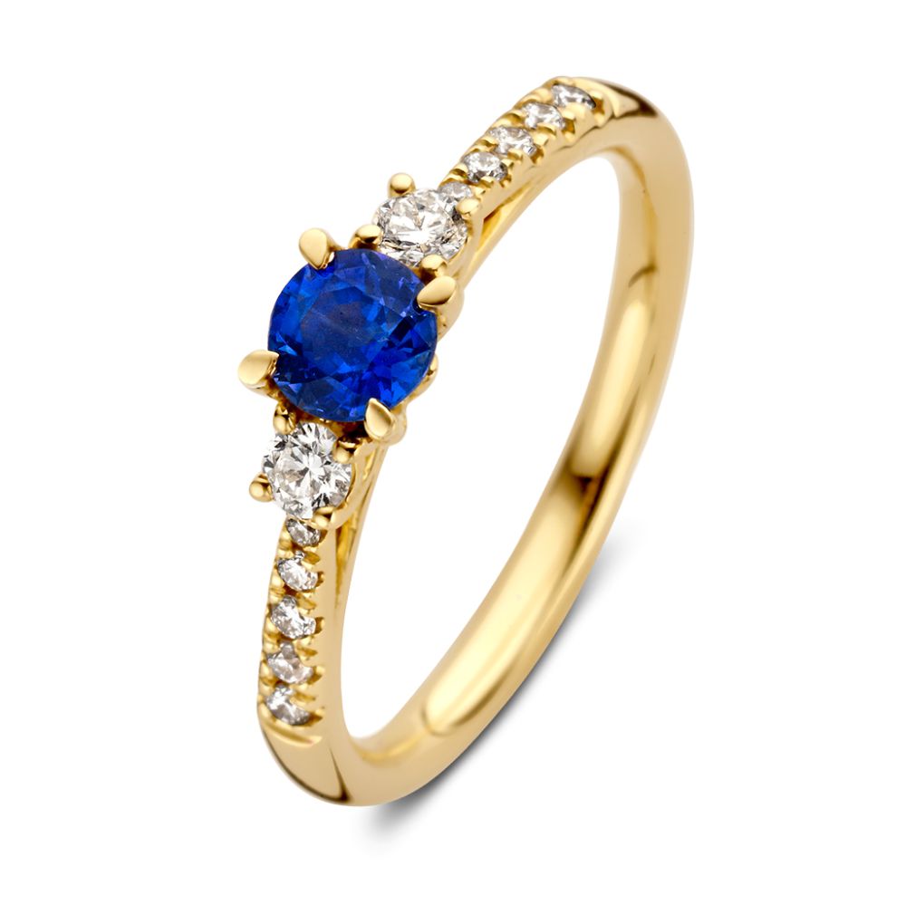 Anillo elegante de oro amarillo con un hermoso zafiro y diamantes brillantes.
