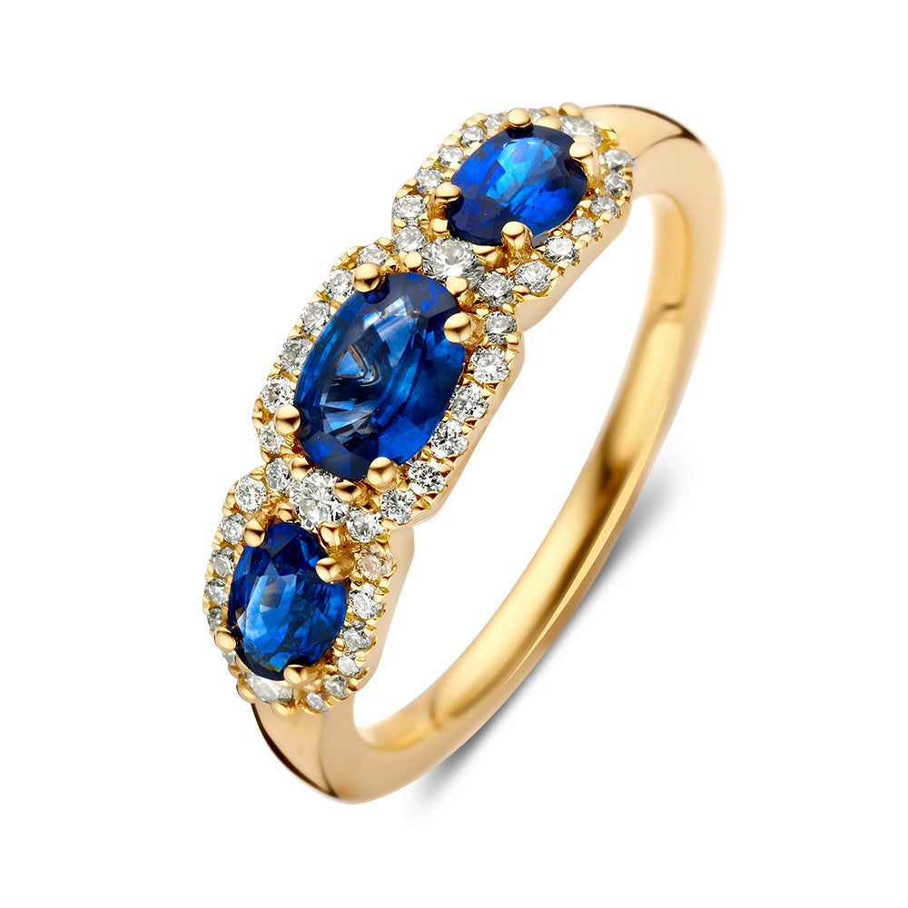 Anillo de oro amarillo con brillantes y zafiros azules.