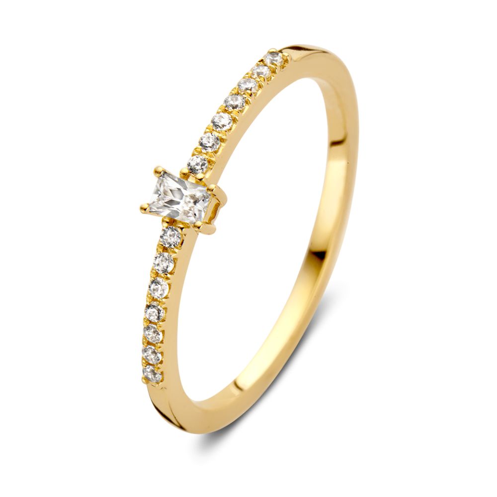 Anillo de oro amarillo con circonitas y piedra central tallada en forma de baguette.