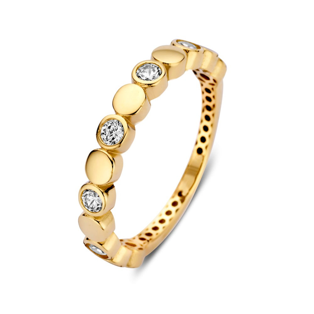 Anillo de oro amarillo con circonitas brillantes y elementos redondos.