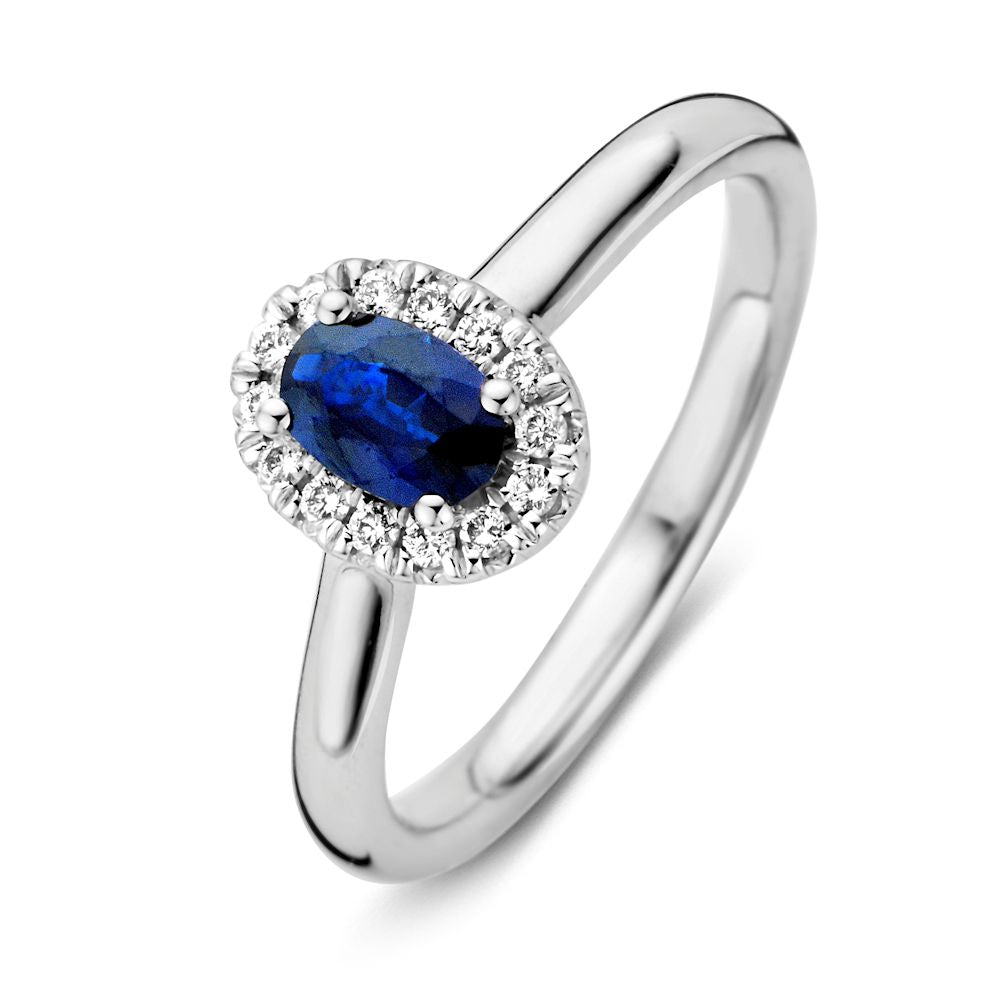 Anillo de oro blanco para dama con zafiro azul y diamantes, con un diseño ovalado y brillante.