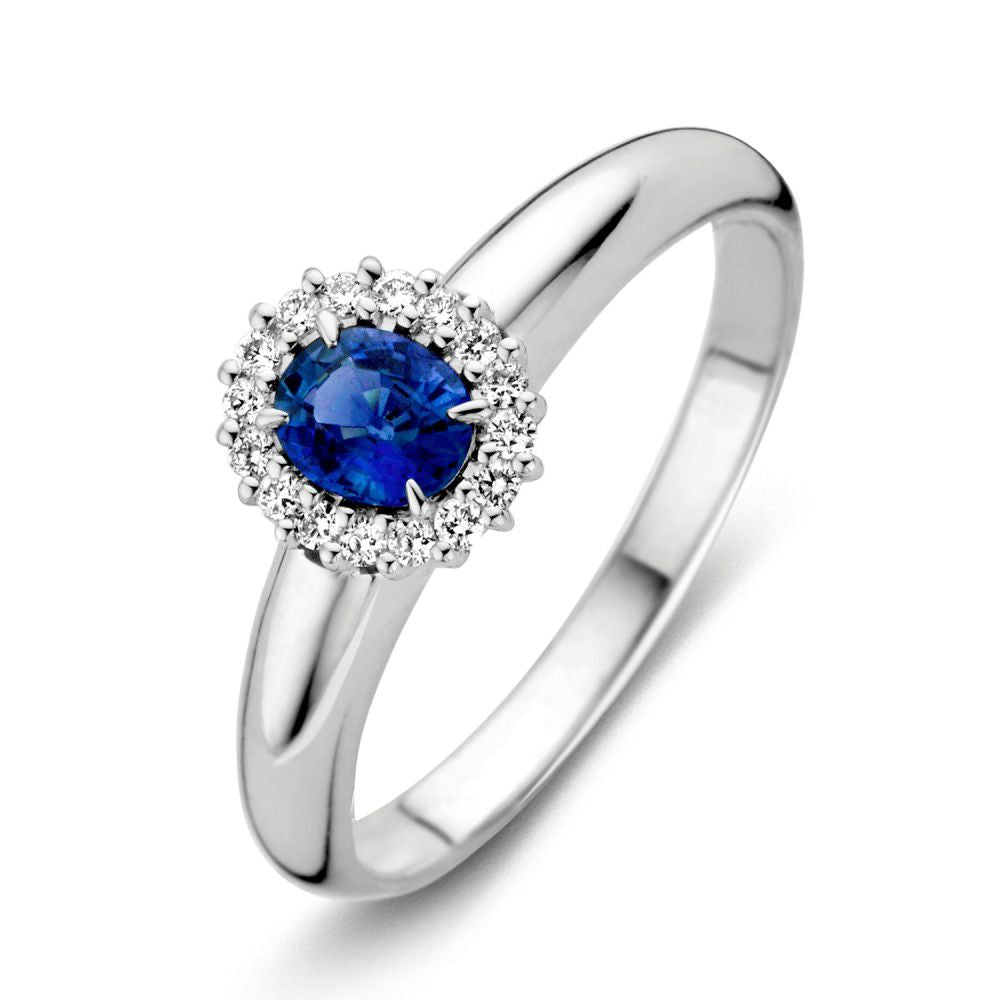 Anillo de oro blanco para dama con zafiro azul y diamantes, diseño ovalado con detalles brillantes.