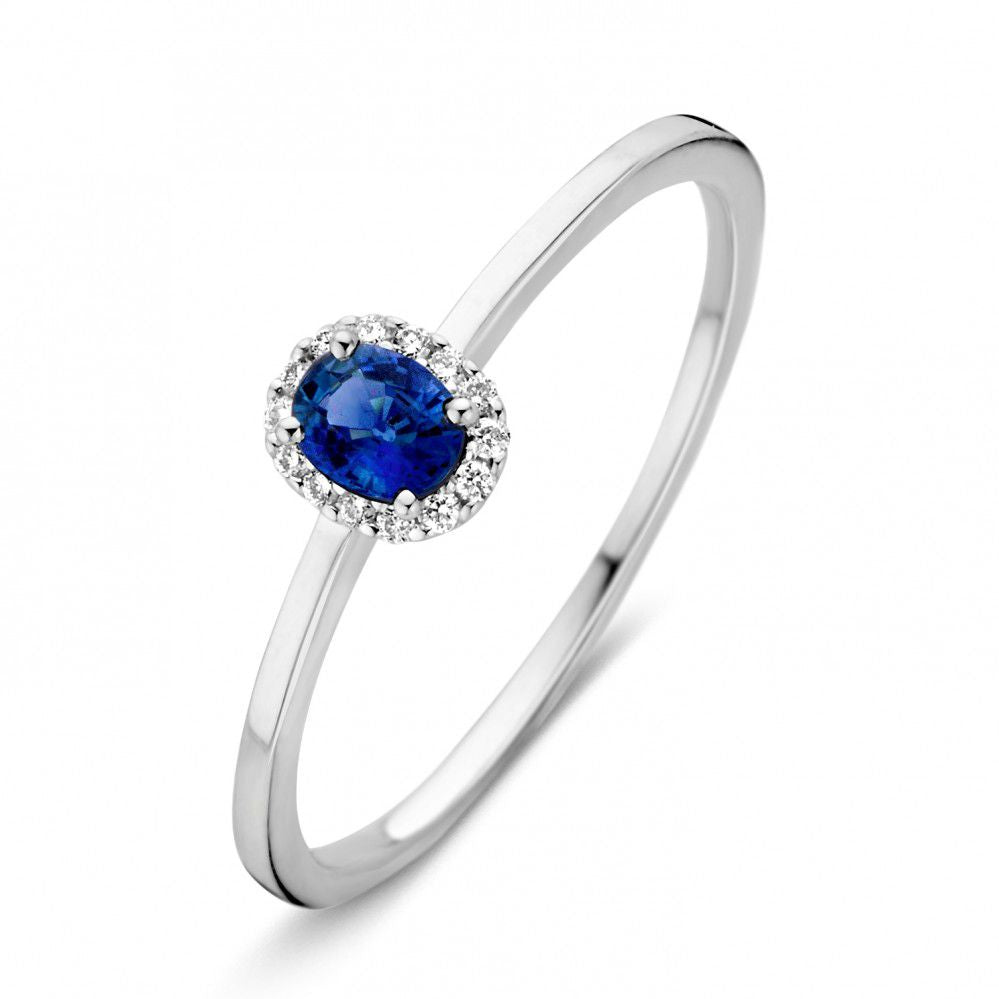 Anillo de oro blanco para dama con zafiro azul y diamantes, diseño delicado y moderno.