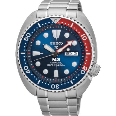Reloj automático Seiko Prospex Sea con esfera azul, bisel rojo y azul, y correa de acero inoxidable.