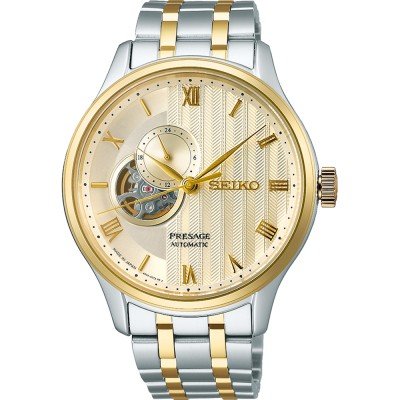 Reloj para hombre Seiko Presage con caja dorada y plateada, esfera dorada y detalles en relieve.