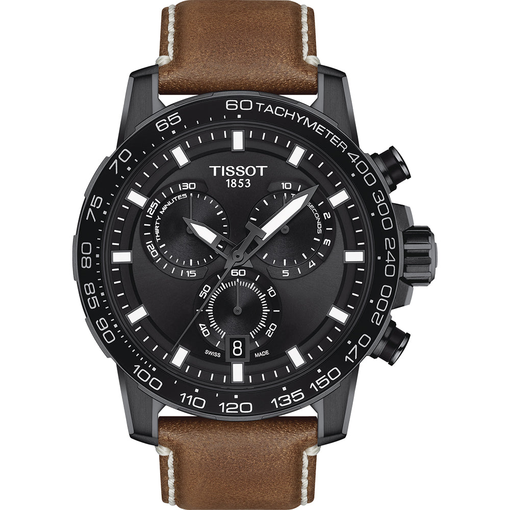 Reloj cronógrafo Tissot con esfera negra, correa de cuero marrón y detalles en blanco.
