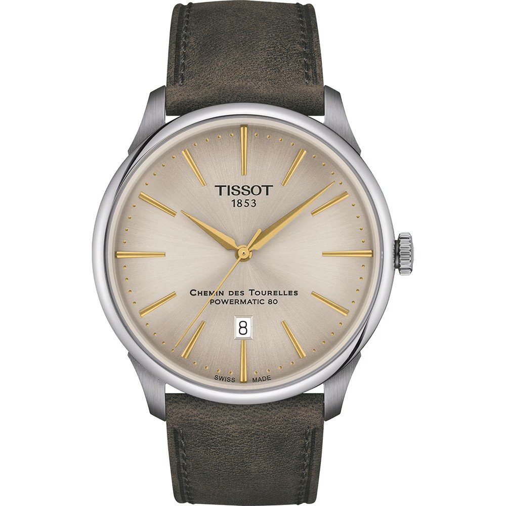 Reloj Tissot Chemin des Tourelles de 42 mm con esfera plateada, manecillas doradas y correa de cuero marrón.