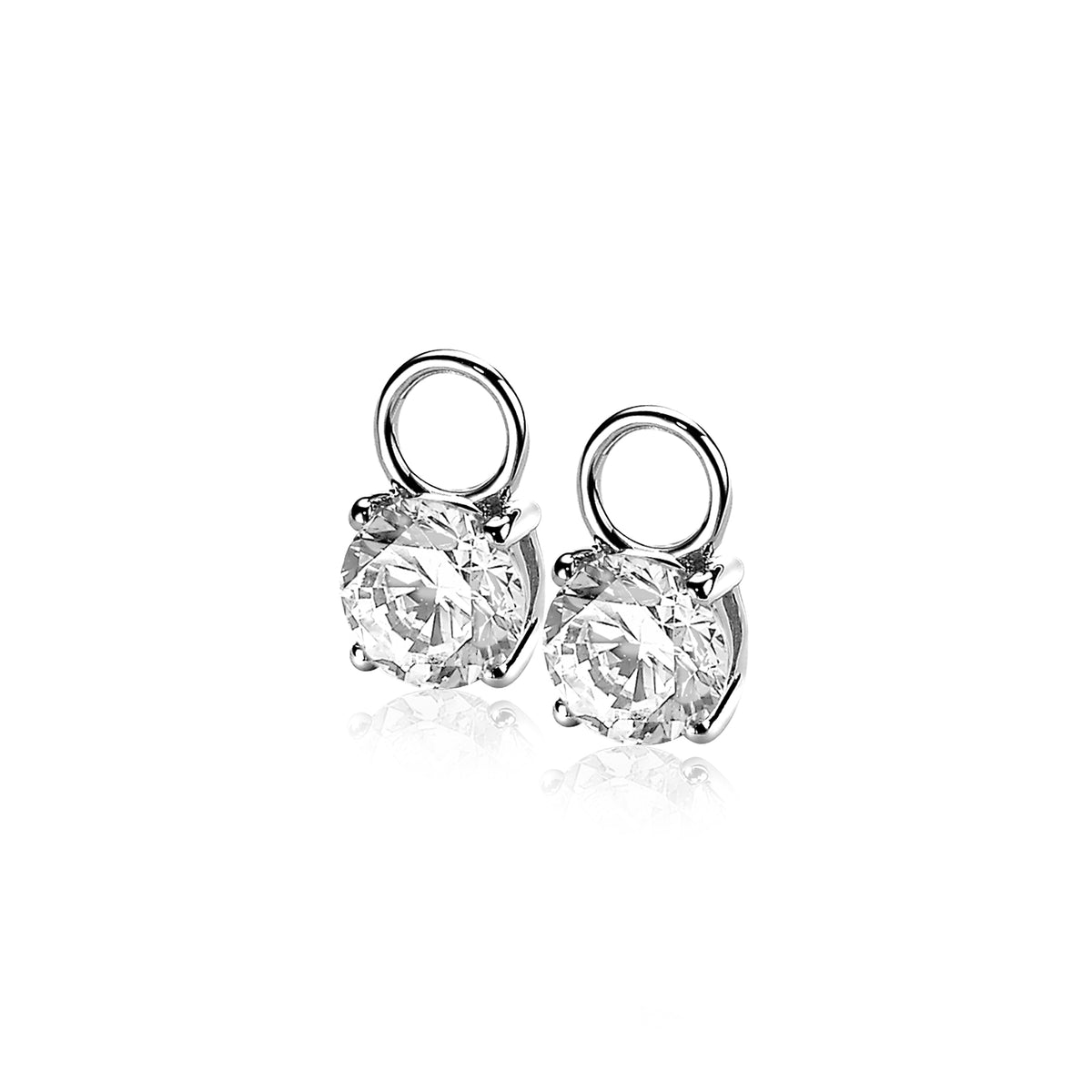 Pendientes de plata con circonitas transparentes en forma de botón.