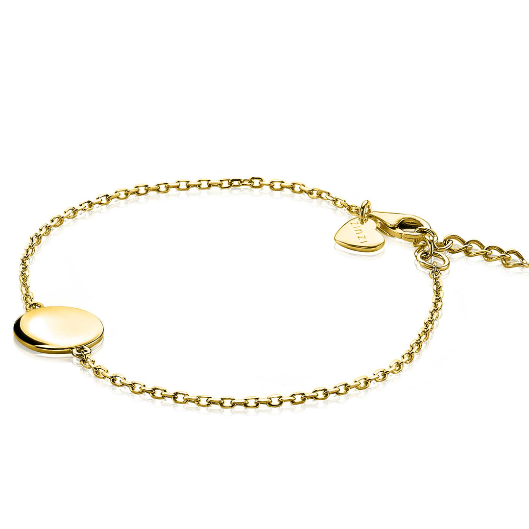 De Zinzi Armband Gold Plated Zia2345 G heeft een centrale ronde schijf en een gegraveerde hartbedel bij de sluiting. De delicate, verstelbare ketting zorgt voor een perfecte pasvorm en straalt eenvoudige elegantie uit voor elke gelegenheid.