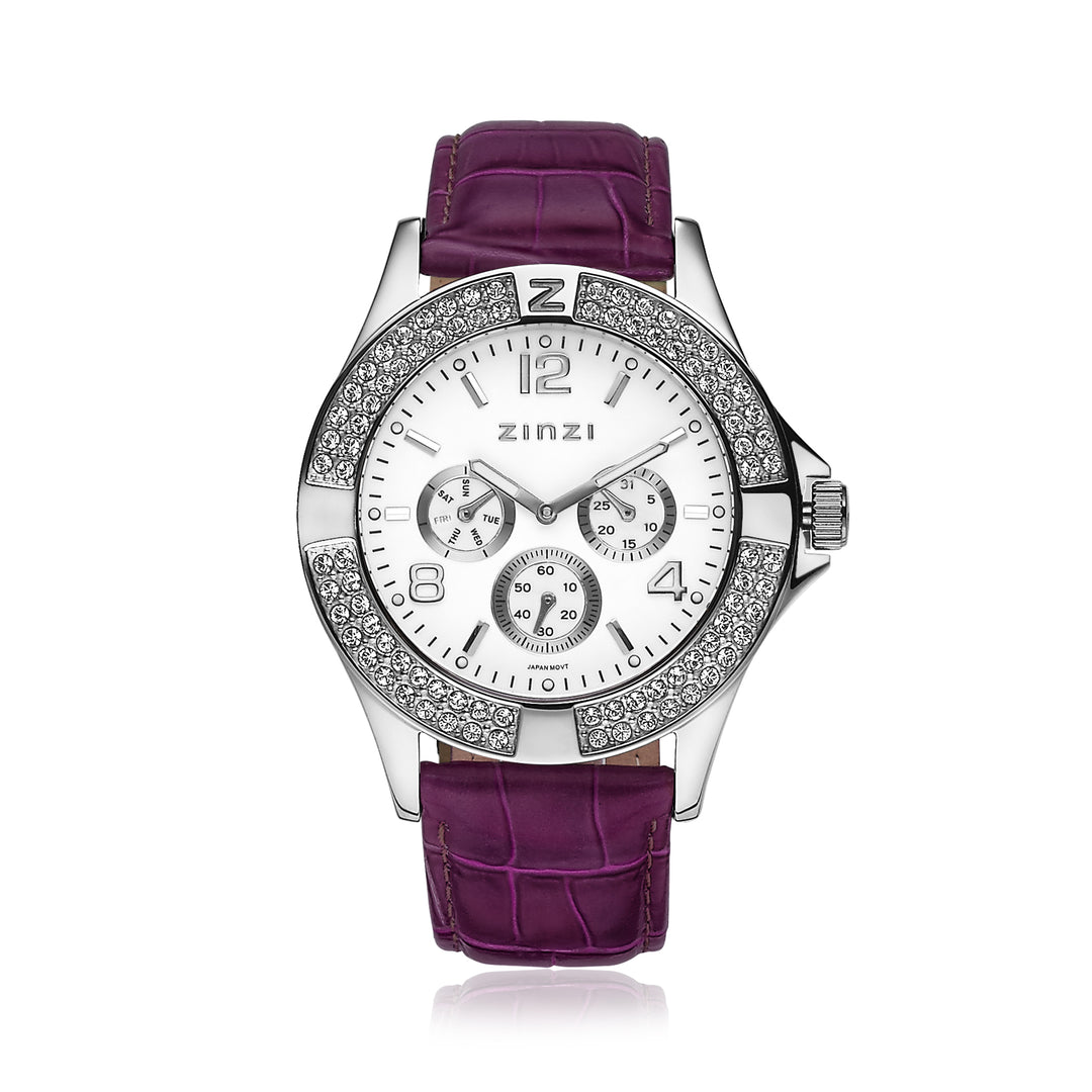 Ontdek de elegantie van het Zinzi Zilverkleurig Horloge Staal Uno4, met een zilveren horloge met een paarse band. Het beschikt over drie subdials, een ronde bezel met kristallen en uurmarkeringen naast de merknaam Zinzi op een witte achtergrond.