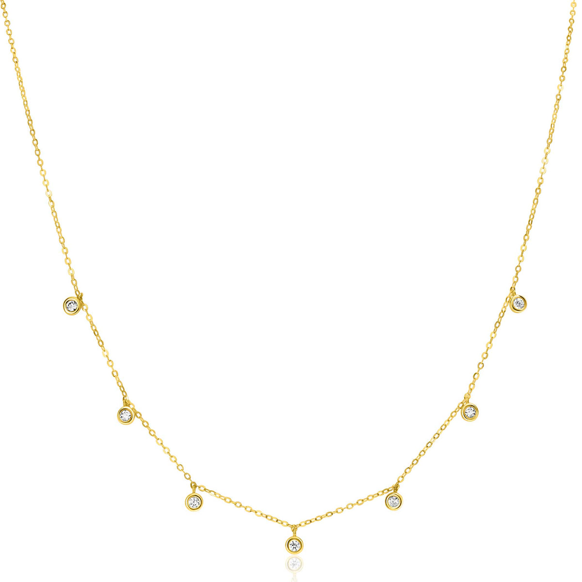 Collar dorado con charms circulares y un colgante central brillante.