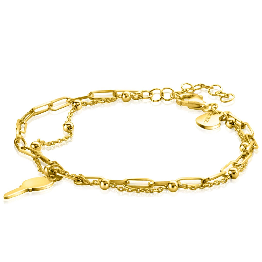 De Zinzi Armband Goud Verguld Zia2357 bestaat uit een elegante mix van schakels en kleine kraaltjes, versierd met een sleutelvormige bedel en een hartvormig label, met een verstelbare sluiting voor een perfecte pasvorm.