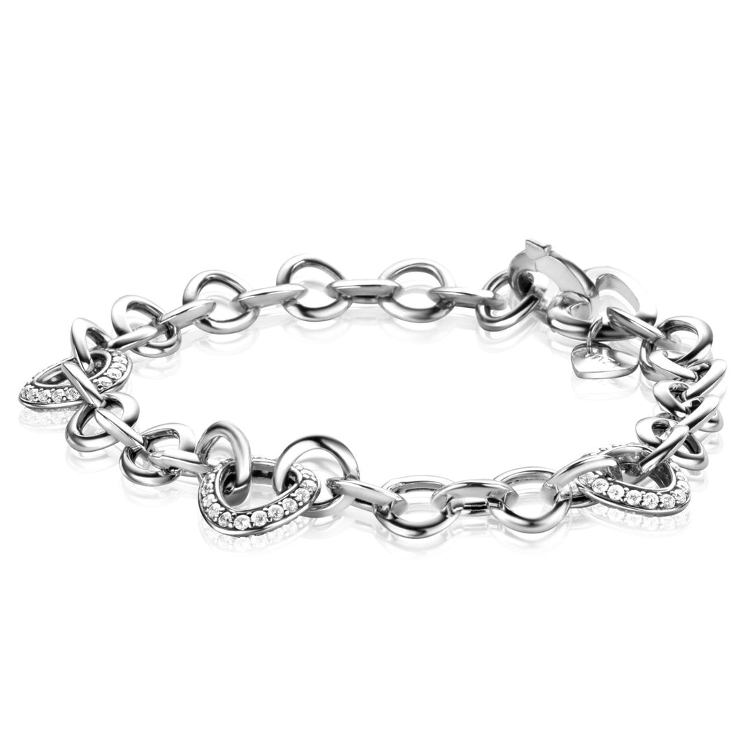 De Zinzi Armband Zilver Zia2388 toont verweven zilveren schakels, waarvan sommige zijn versterkt met witte zirkonias. Het heeft een glanzende afwerking en een sluiting met gesp, wat de elegantie van het merk Zinzi belichaamt.
