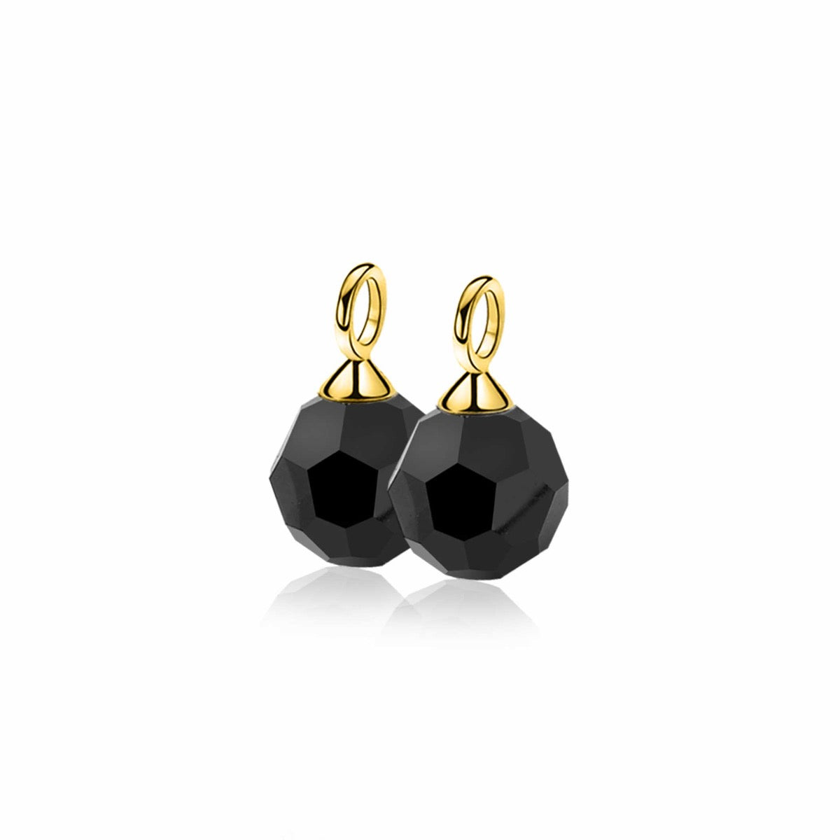 Pendientes largos dorados con piedras negras facetadas.